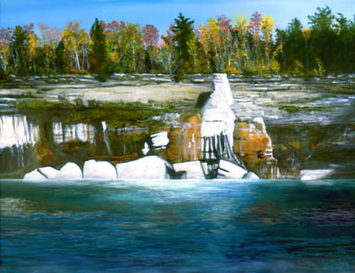 High wall of rock with trees along the top with rough waters, rocks, sunlight